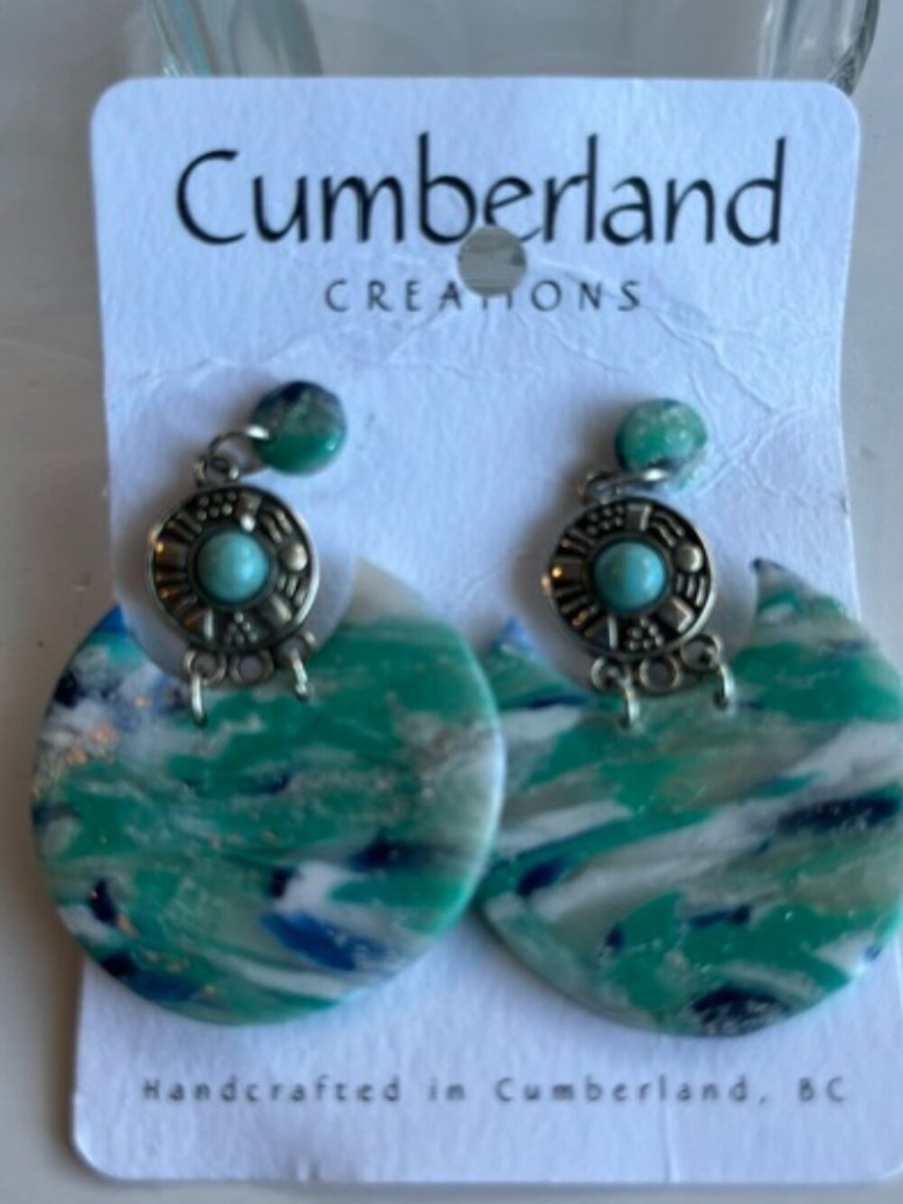 Cumberland creations sea moon earrings.